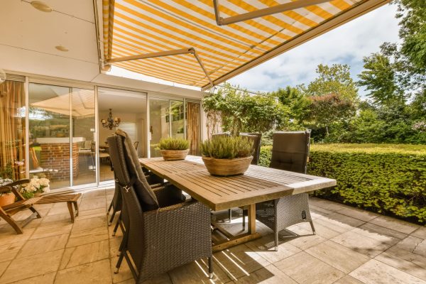 a-patio-with-a-wooden-table-and-chairs-under-a-2025-02-10-08-31-29-utc(1)